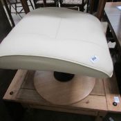 A cream leather footstool