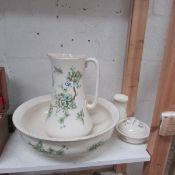 A jug and basin set with soap dish and a toothbrush jar