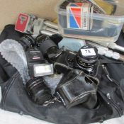 A quantity of photographic items including camera, lenses, tripod etc