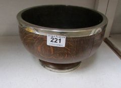 A wooden fruit bowl with silver plated rim