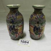 A pair of small enamelled Oriental vases
