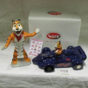 A Wade Kellogg's Tony The Tiger in racing car money box and a Wady Tony the Tiger figurine