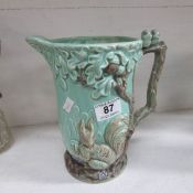 A Wadeheath jug with squirrel and birds, circa 1936-48, slightly a/f