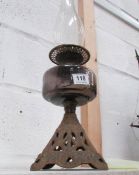 An oil lamp with metal base and brass font