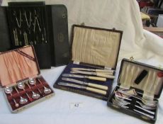 A cased drawing set and 3 boxed cutlery sets