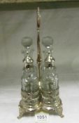 A 4 bottle cruet on silver plated stand