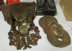 A carved Black Forest shelf and an African mask