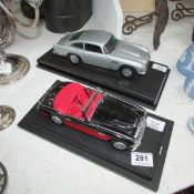 2 model cars being an Aston Martin and an Austin Healey