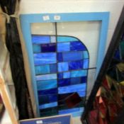 A framed leaded and stained glass panel