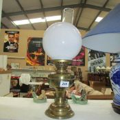 A brass oil lamp with shade