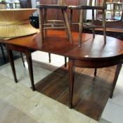 A mahogany double D end extending dining table