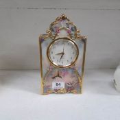 A porcelain clock decorated with birds