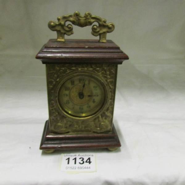 A wood and brass carriage clock by The British United Clock Company, Birmingham