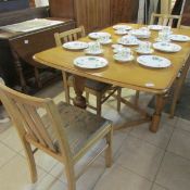 An oak drop leaf dining table and 4 chairs