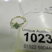 A 4 stone emerald and centre diamond yellow gold ring, size N