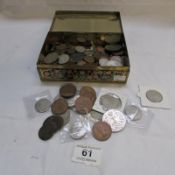 A tin of mostly copper coins