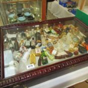 A glass topped jewellery display contents and miniature wines and spirits