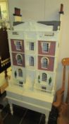 A Georgian style dolls house on stand