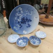 4 small blue and white plates and a blue and white charger