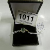 A 9ct gold ring set 8 diamonds and central emerald, size P