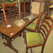 An oak dining table and 6 ladder back chairs