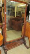 A Georgian mahogany cheval mirror with original brass candle sconces