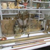A brass fan firescreen, brass fender, brass companion set, door stop and poker