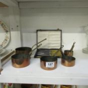 5 graduated copper pans and a cased set of butter knives
