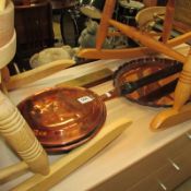 A copper warming pan, copper tray and brass crib board