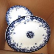 A blue and white meat platter and dinner plates