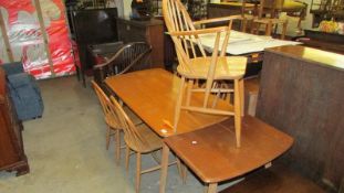 An Ercol kitchen table, 5 chairs including carver and table extension