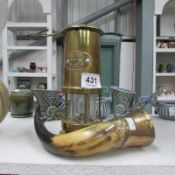 A brass miner's lamp with 'CYMRU' plaque and an animal horn with brass fittings