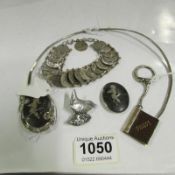 A silver hair band, 2 silver brooches, a white metal bird pin, white metal coin bracelet and unusual