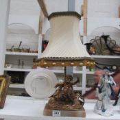 A gilded French table lamp in the form of a Cherub riding a swan
