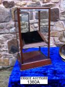 A table top mahogany and bevelled glass mirror door display cabinet