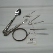 6 white metal cocktail sticks, a silver handled spoon and fork and a silver bangle