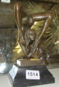 A bronze lady contortionist