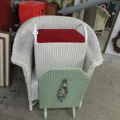 A Lloyd Loom chair and linen bin together with a loom style fire screen