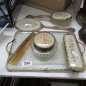 A dressing table set inset with lace and embroidered panels