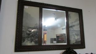 A bevel edged oak framed mirror with cattle prints