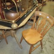 An oval pine kitchen table and 4 chairs