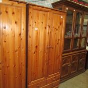 A pine wardrobe with drawer base