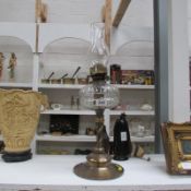 A brass and glass oil lamp