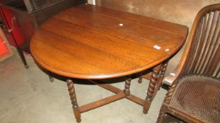 An oak barley twist gate leg table