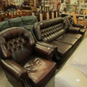 A brown leather button backed 3 piece suite