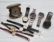 A quantity of ladies and gent's wristwatches and a travel clock