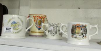 A Wade loving cup, castle butter dish, biscuit barrel and 2 a/f jugs