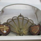 A brass fan shaped fire screen and 2 wall plaques