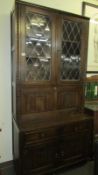 An oak priory style bookcase with linen fold panels