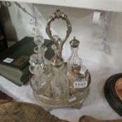 A 6 bottle cruet on silver plated stand